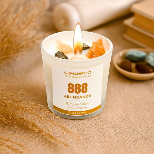 Gemanifest 888 Abundance candle with crystals on a textured surface
