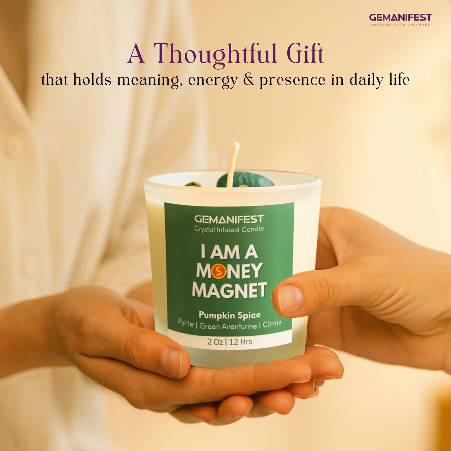 Candle with 'I AM A MONEY MAGNET' label held by hands against a beige background