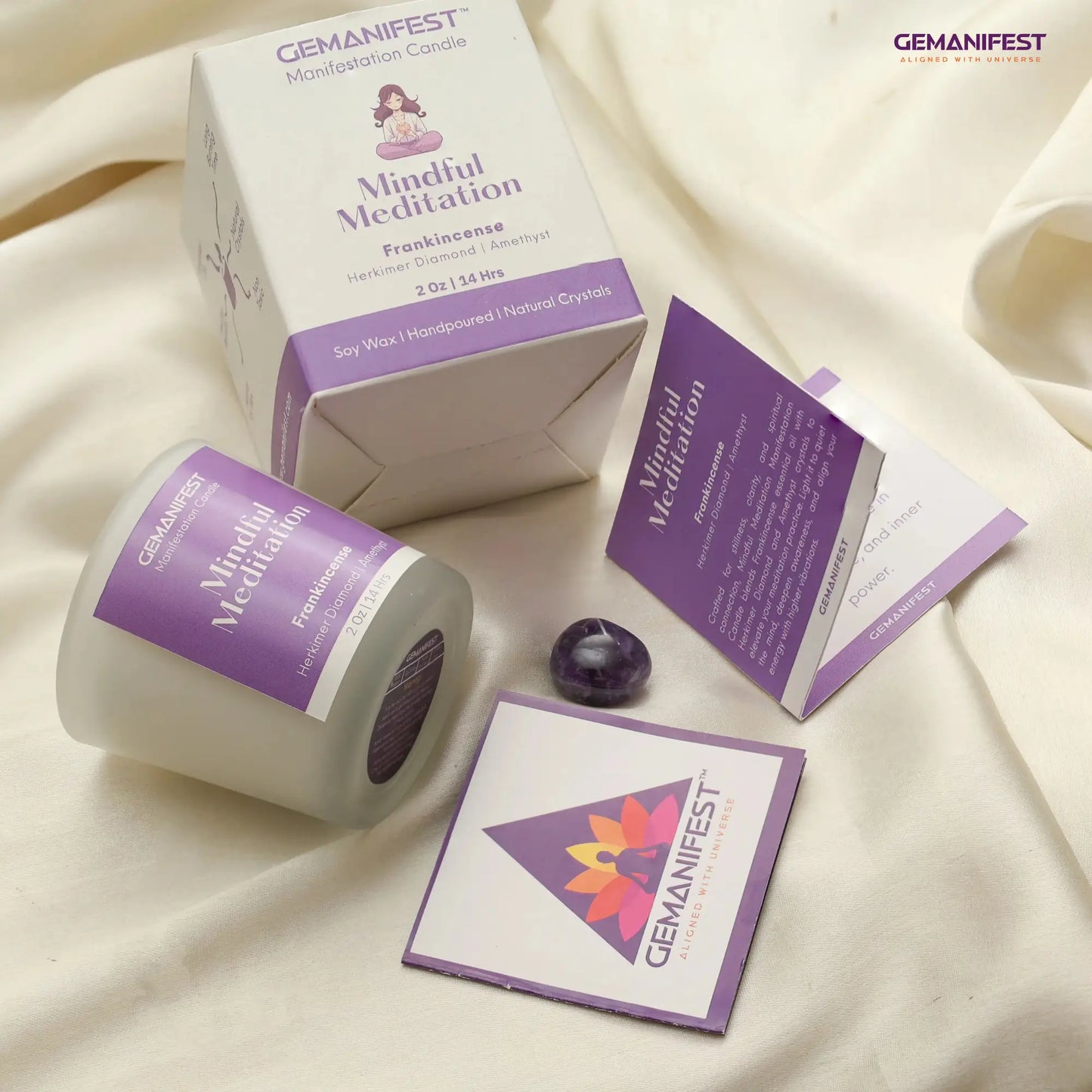 Gemanifest Mindful Meditation candle and packaging on a beige fabric background