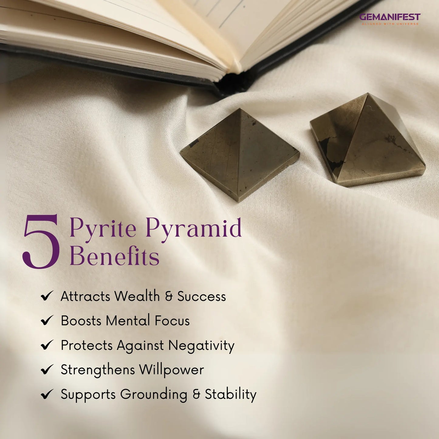 Two pyrite pyramids on a fabric surface with benefits, branded 'GEMANIFEST'.