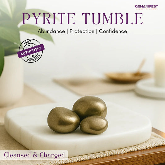 Pyrite tumble on a white platform with a blurred background