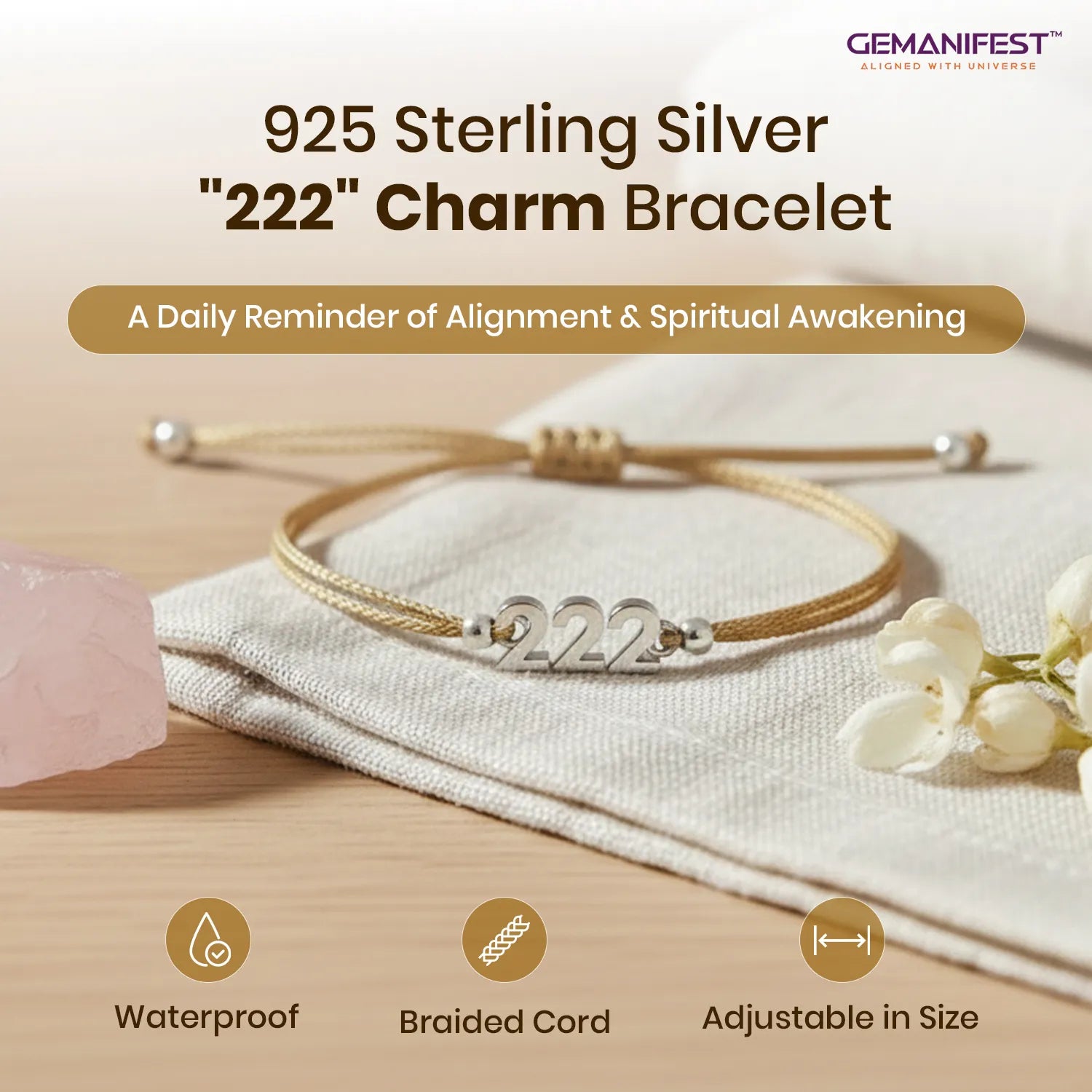 925 Sterling Silver '222' Charm Bracelet on a wooden surface with flowers and a crystal, featuring GEMANIFEST branding.