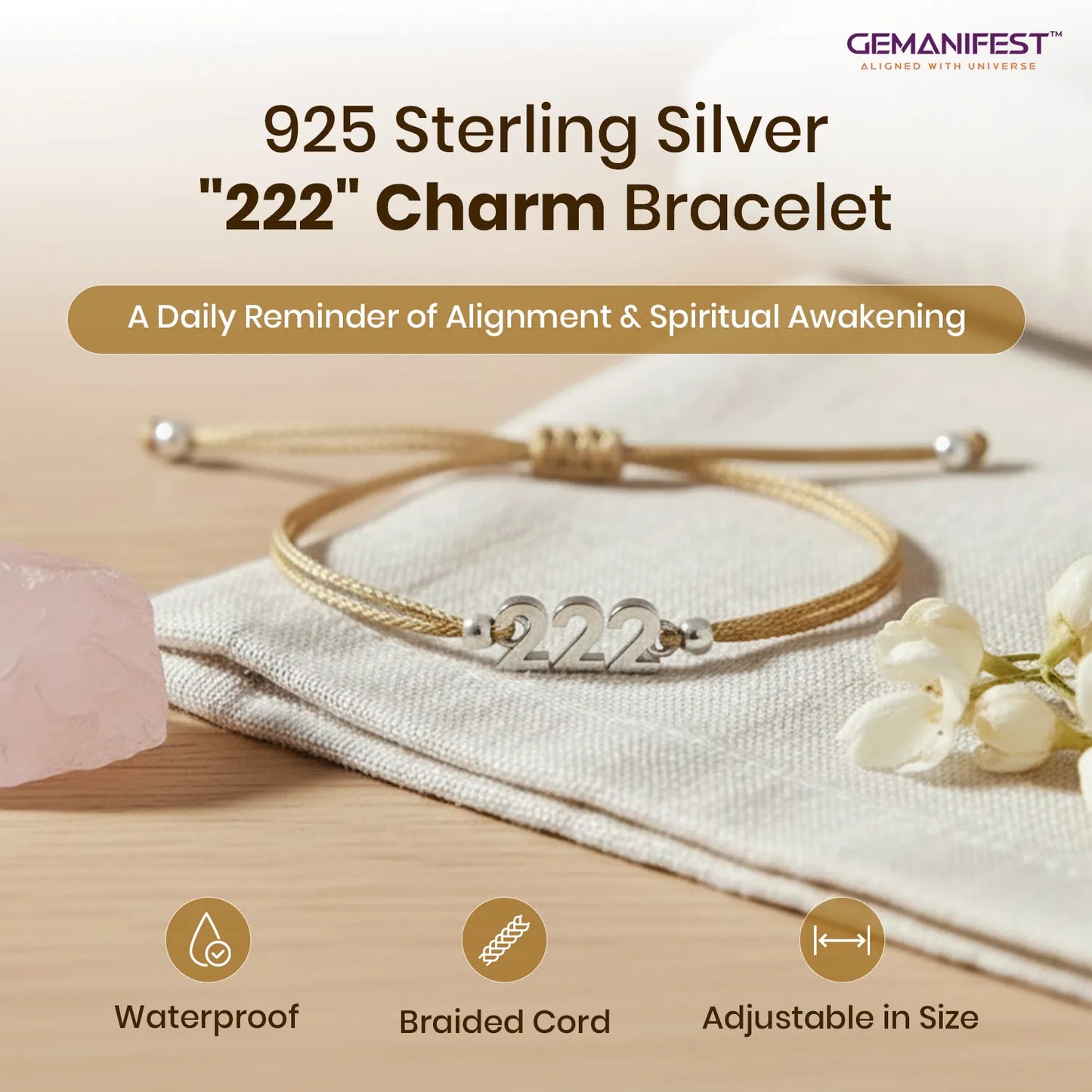 925 Sterling Silver '222' Charm Bracelet on a wooden surface with flowers and a crystal, featuring GEMANIFEST branding.
