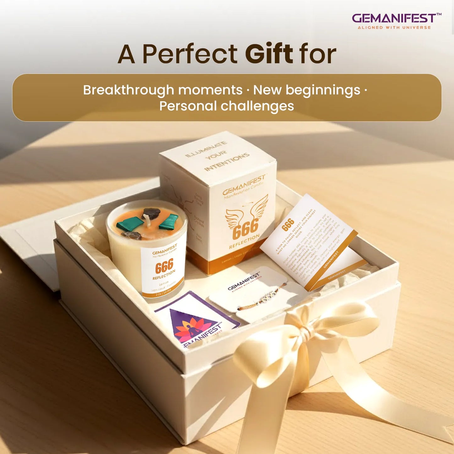 Gift set with candle, cards, and box labeled 'GEMANIFEST' on a wooden surface.