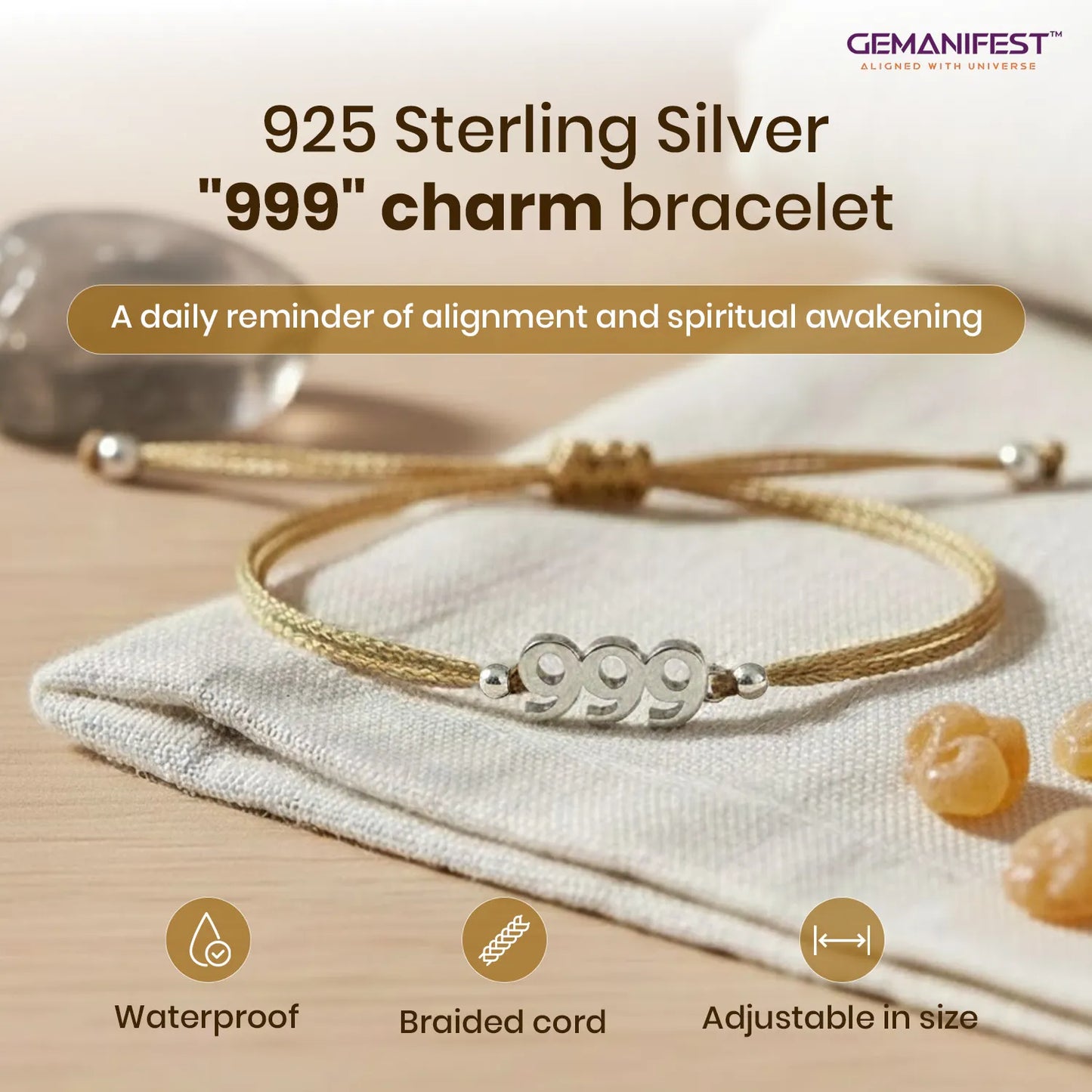 925 Sterling Silver '999' charm bracelet on a beige fabric background with GEMANIFEST branding.