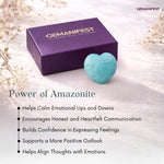 Amazonite stone and purple box with 'GEMANIFEST' branding on a light background