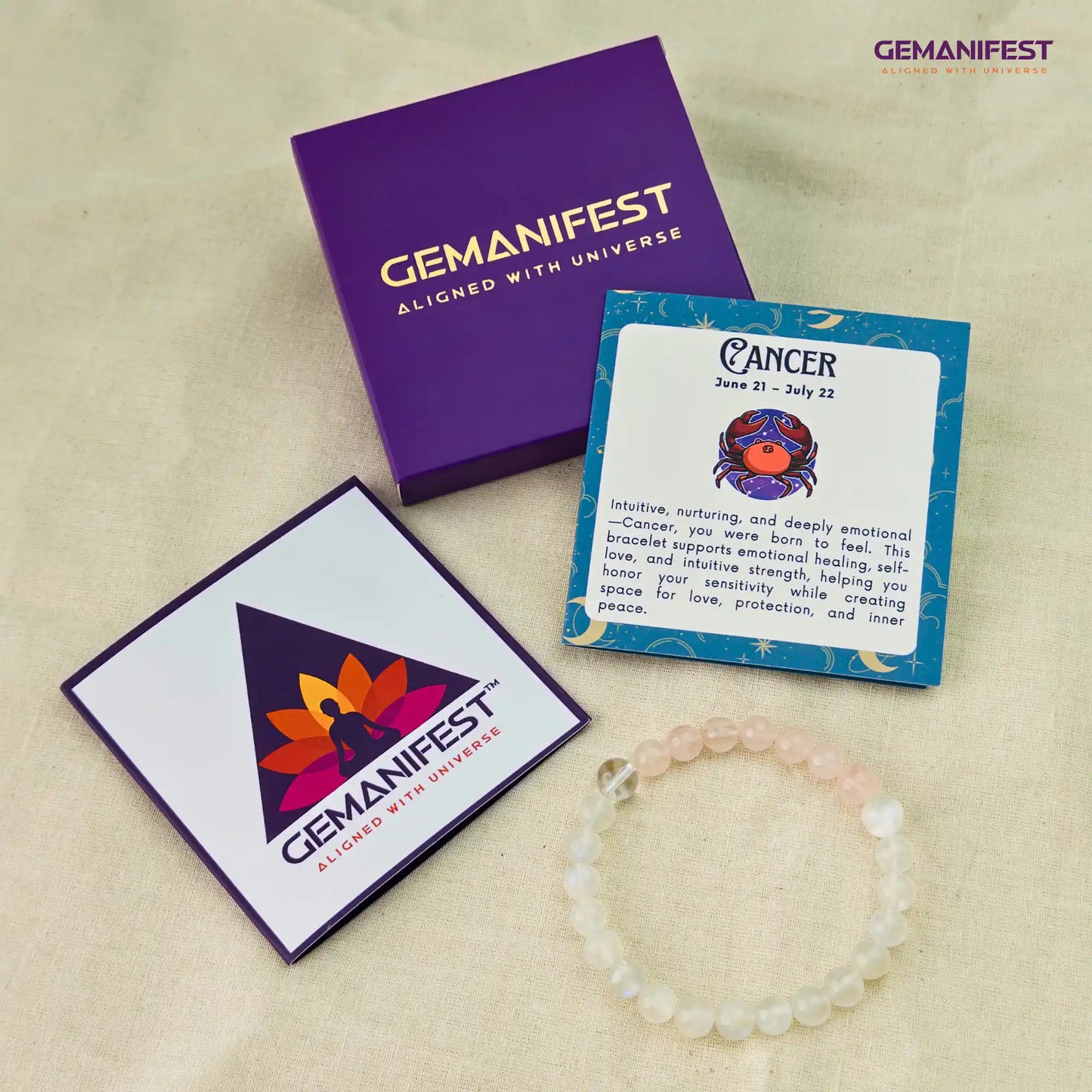 Gemanifest products including a bracelet, cards, and packaging on a beige background