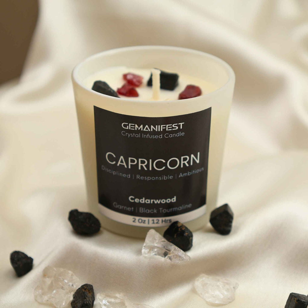 Capricorn Zodiac Manifestation Candle with Garnet and Black Tourmaline crystals and Cedarwood essential oil for discipline and protection.