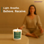 Candle placed in focus with blurred woman meditating in background.
