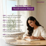 Woman writing in a notebook with a cup of coffee, surrounded by text on a 'Daily 1 Minute Manifestation Ritual'.