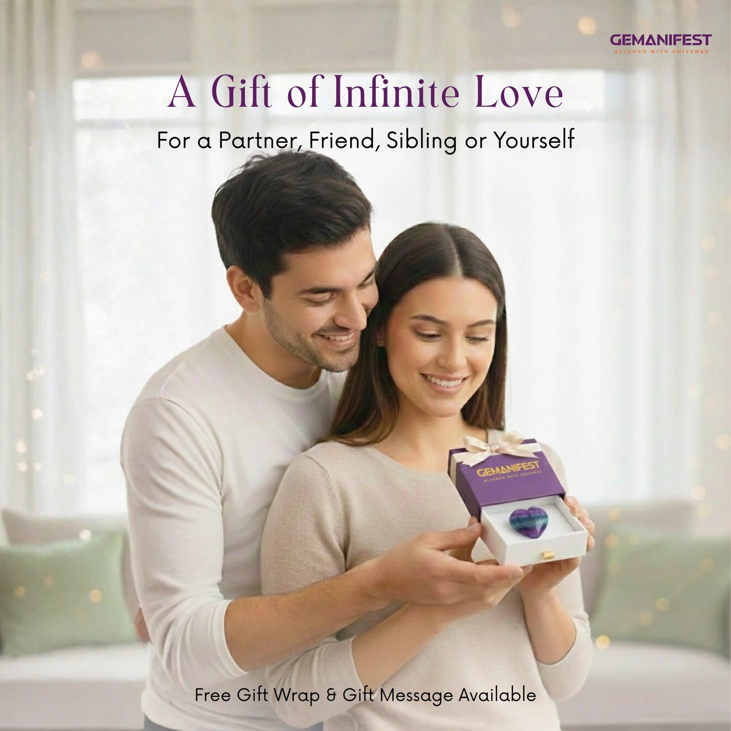 Couple holding a box with 'GEMANIFEST' on a soft focus background