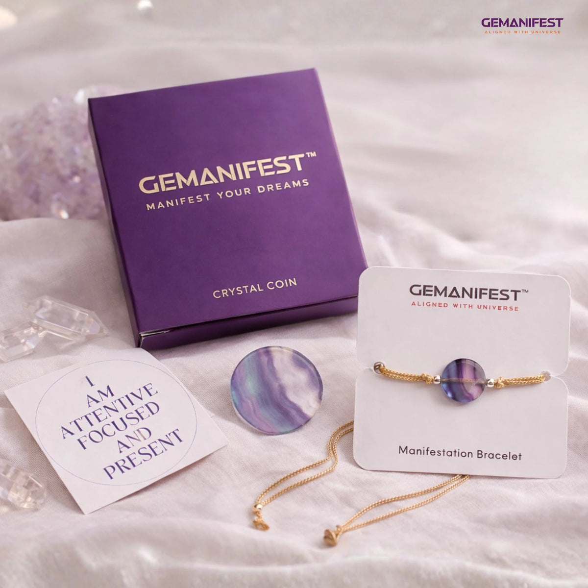 Gemanifest Fluorite coin and bracelet on a white fabric background