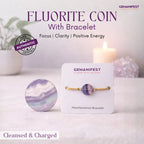 Fluorite coin with bracelet on a card, branded 'Gemanifest', with a candle and crystals in the background.