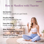 Woman sitting in a meditative pose holding a Fluorite coin with text on how to manifest with fluorite.