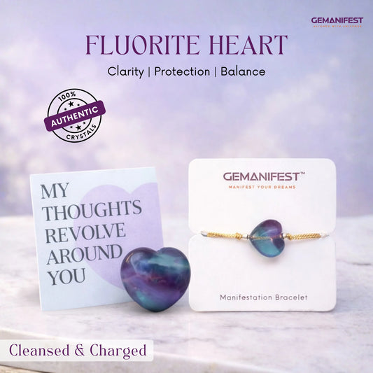 Fluorite heart crystal with GEMANIFEST packaging on a soft background
