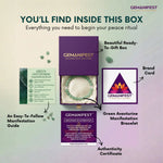 GEMANIFEST product packaging with bracelet, guide, and certificate on a light purple background