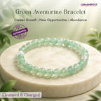 Green aventurine bracelet on a white stone surface with greenery in the background, featuring GEMANIFEST branding.