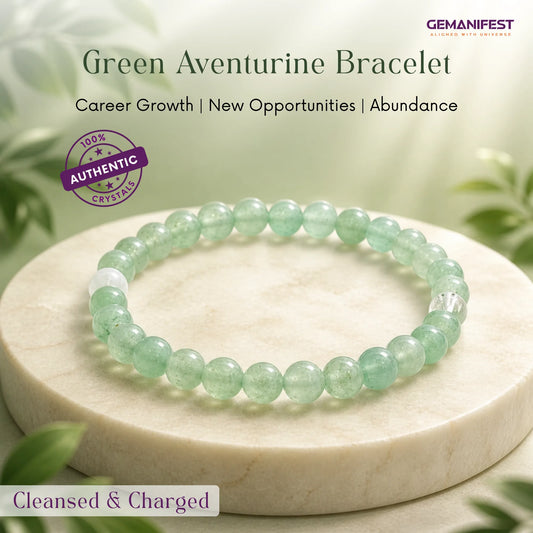 Green aventurine bracelet on a white stone surface with greenery in the background, featuring GEMANIFEST branding.