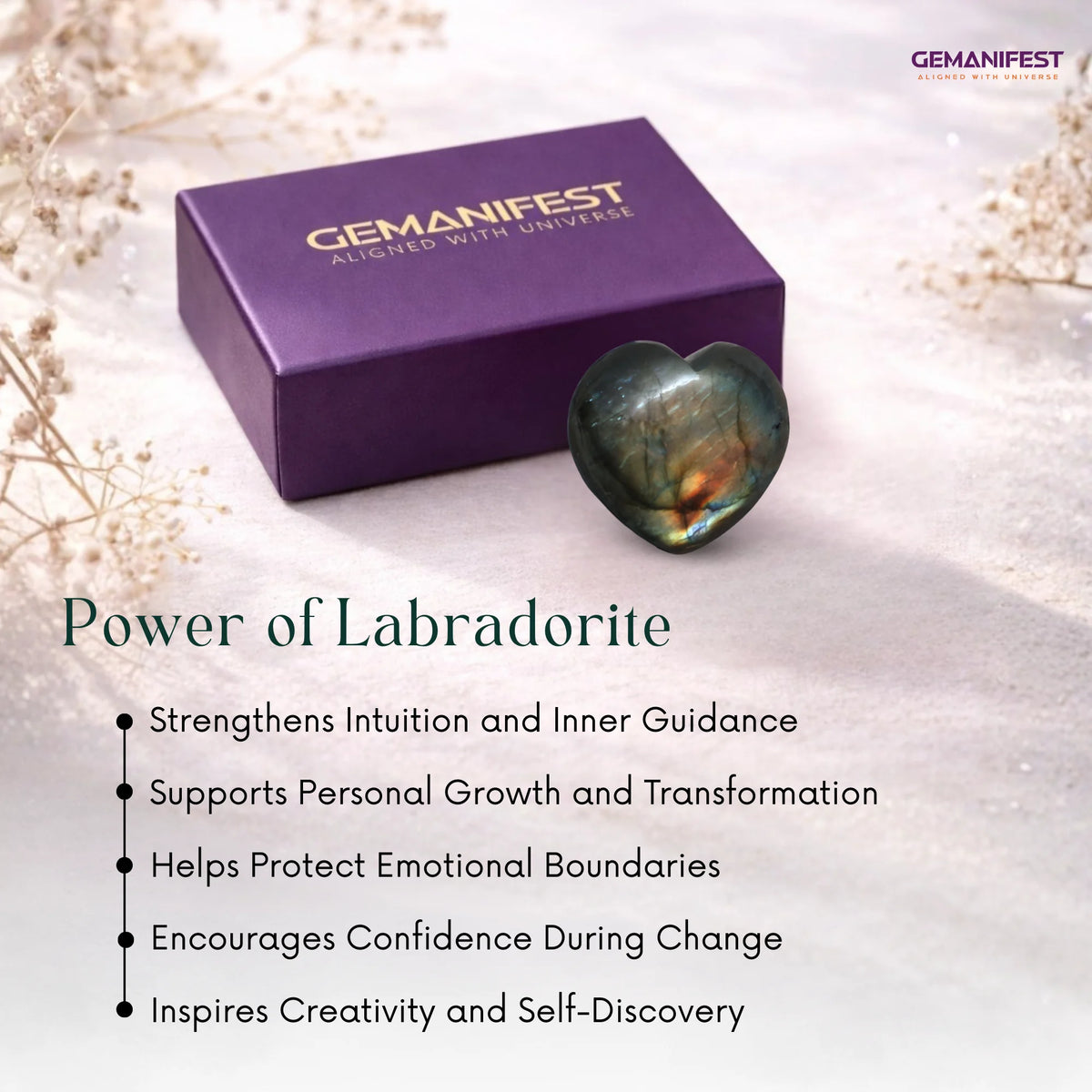 Purple 'GEMANIFEST' box with a heart-shaped Labradorite stone on a light background