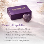 Purple gemstone box with a heart-shaped lepidolite crystal on a light background, featuring Gemanifest branding.