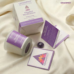 Gemanifest Mindful Meditation candle and packaging on a beige fabric background
