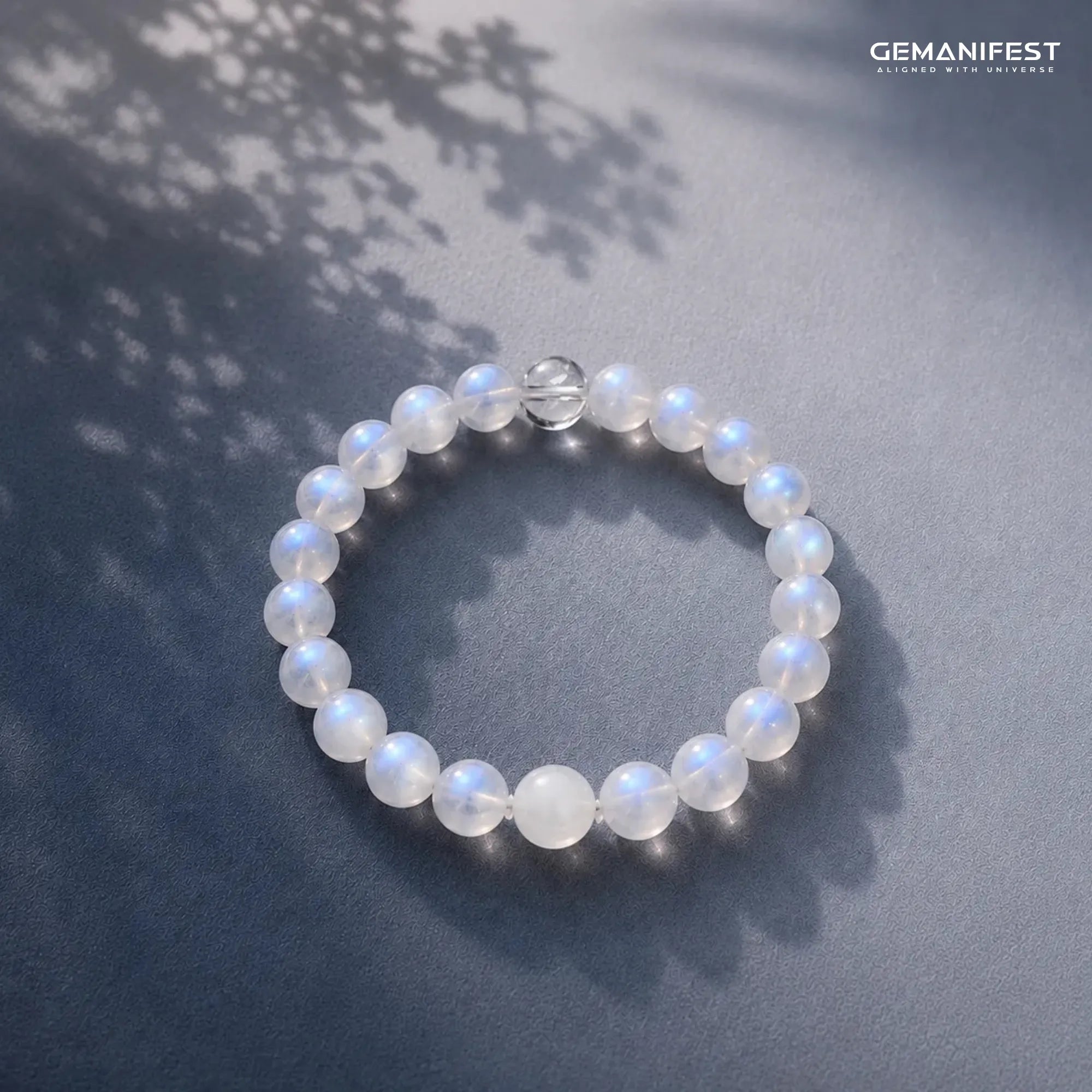 Beaded bracelet on a dark surface with leaf shadows