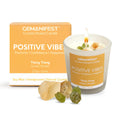 Gemanifest Positive Vibes crystal infused candle with packaging and crystals on a white background