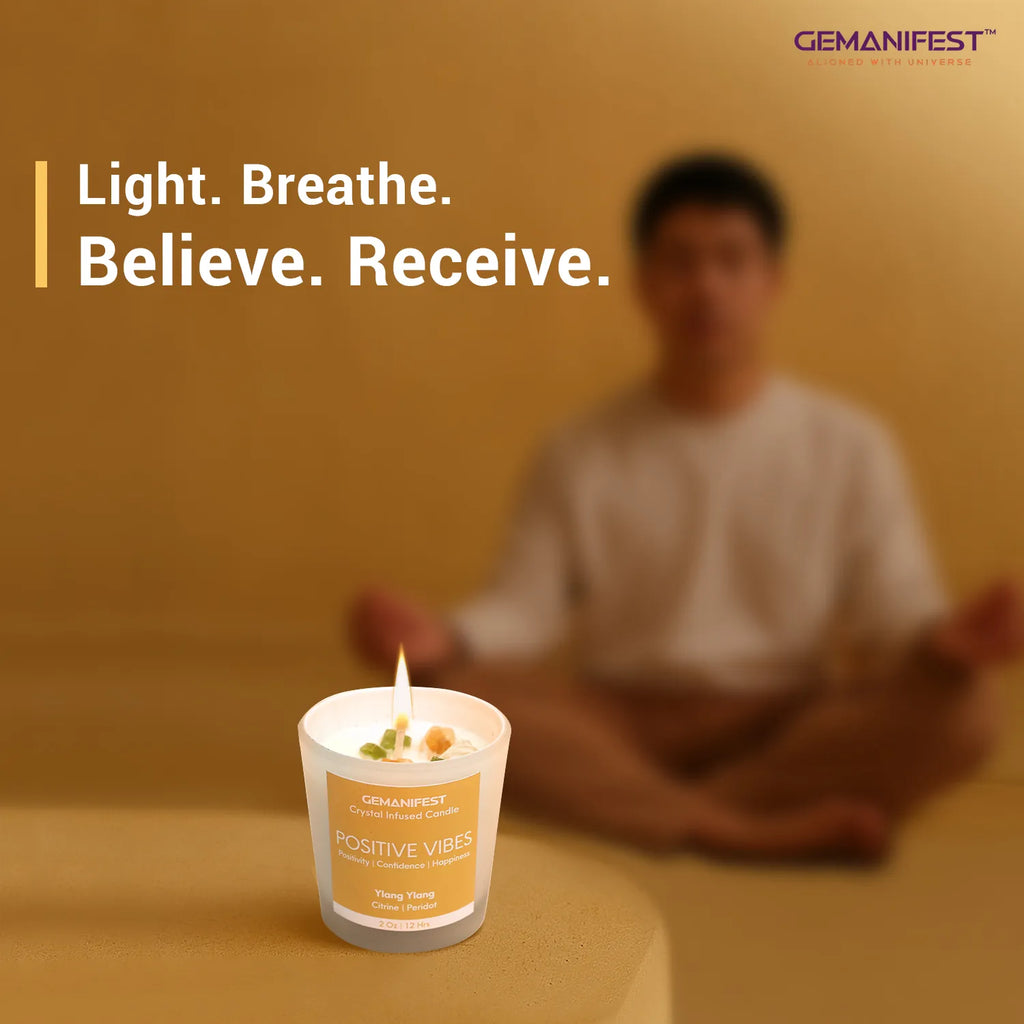Positive Vibes manifestation candle placed in front of meditating person.