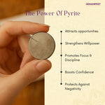 Hand holding a pyrite coin with its benefits listed on a beige background