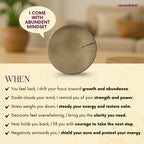 Decorative Pyrite Coin with motivational text on a blurred indoor background