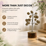 Decorative tree on a table with text about its benefits, set against a blurred indoor background.