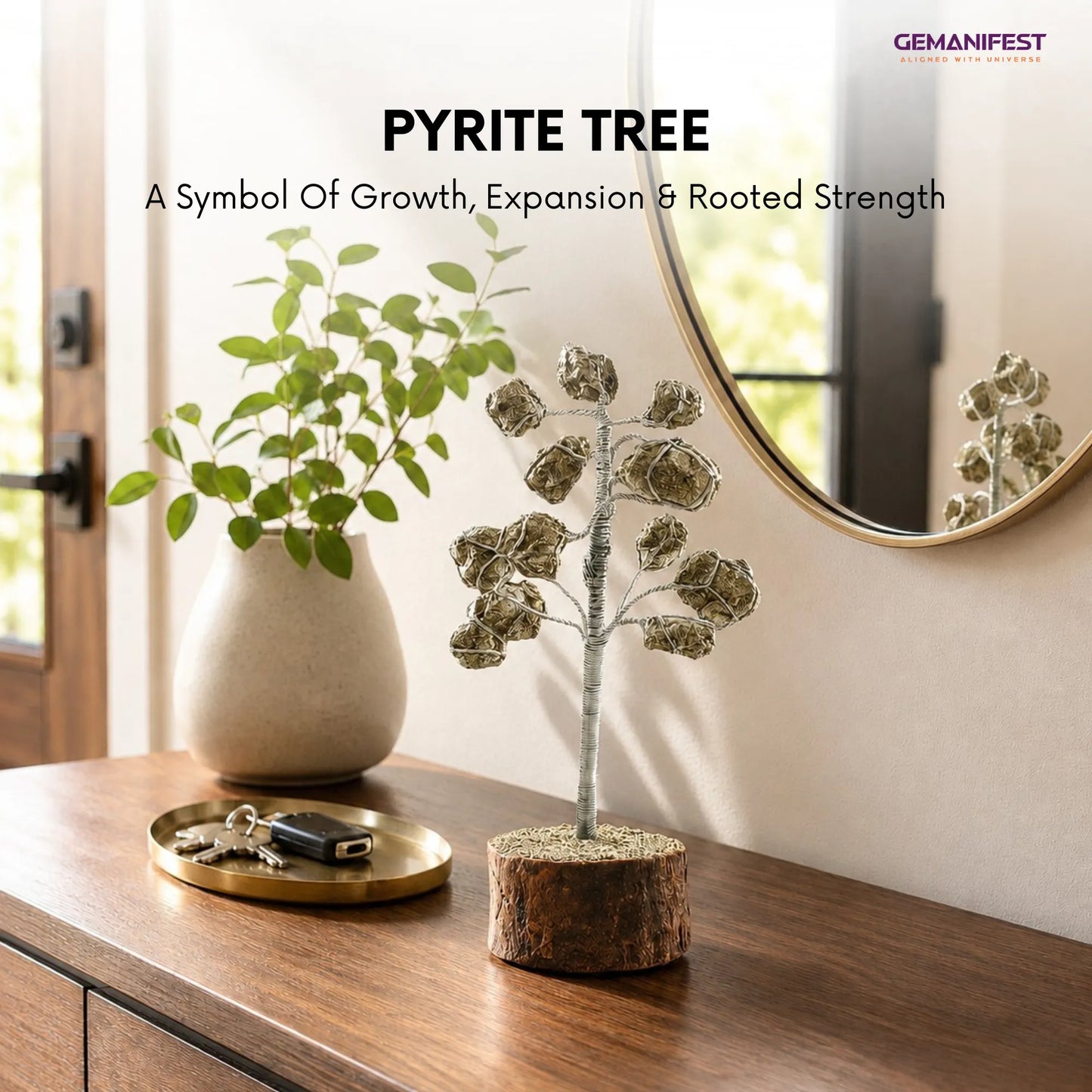 Decorative pyrite tree on a wooden surface with a vase and mirror in the background.