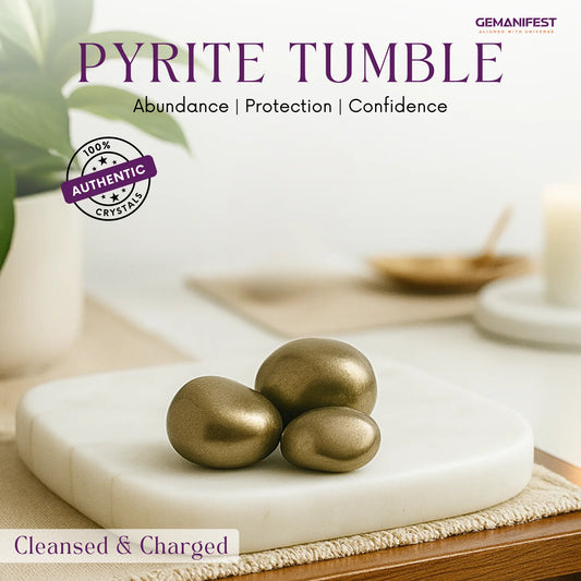 Pyrite tumble on a white platform with a blurred background