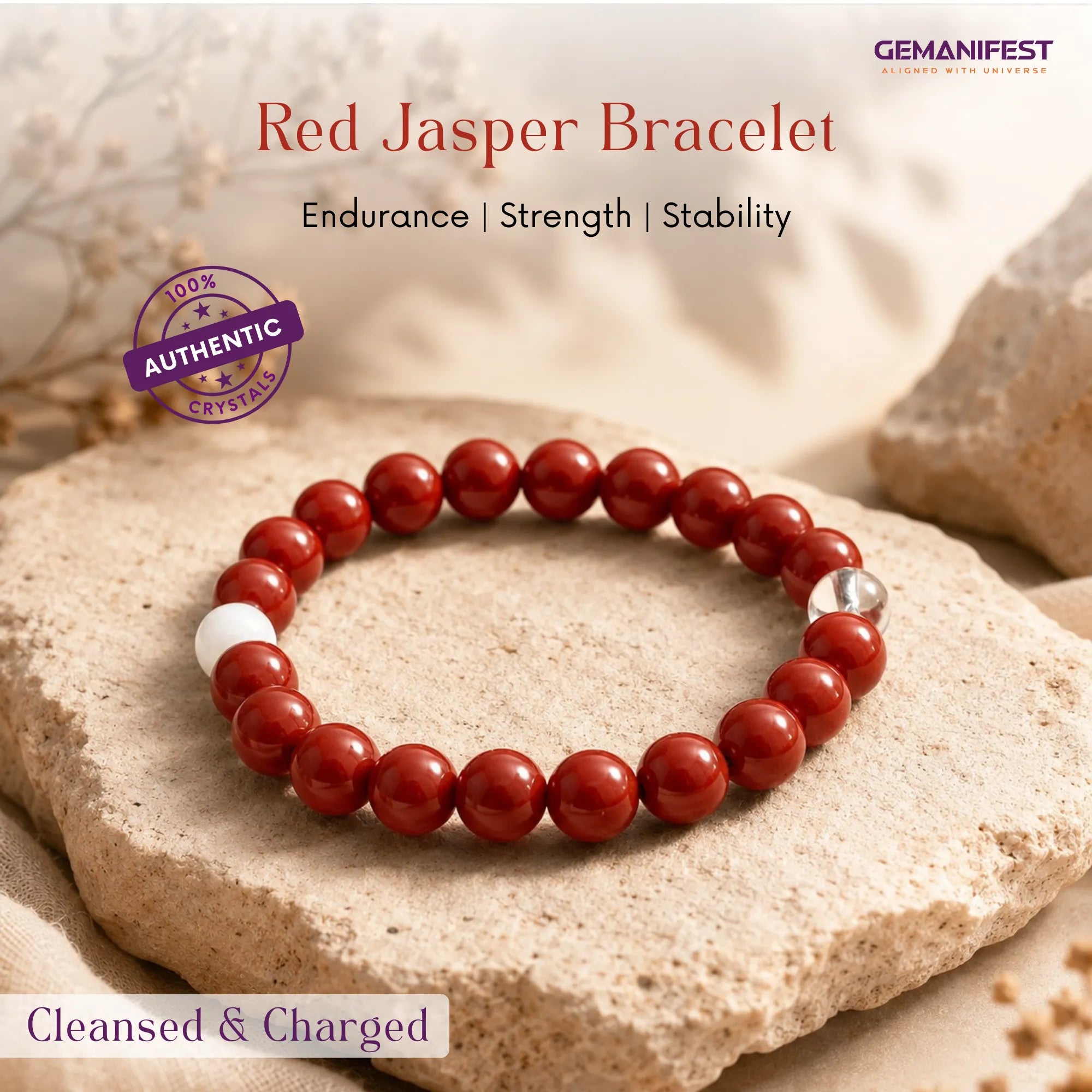 Red Jasper bracelet on a stone surface with 'GEMANIFEST' branding.