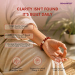 Person wearing a bracelet with text about gemstone beads and GEMANIFEST branding.