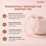 Rose Quartz stone bracelet with a cup on a light pink background, featuring GEMANIFEST branding.