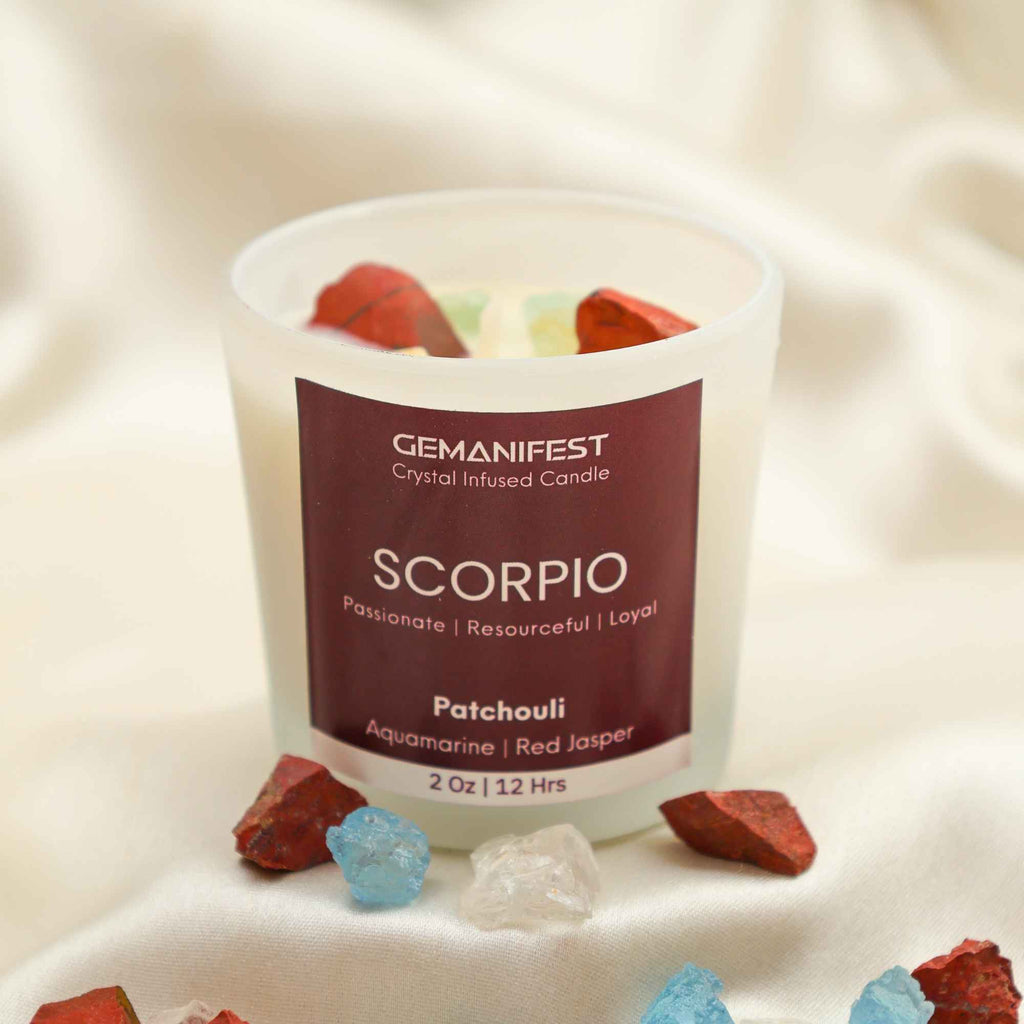 Scorpio Zodiac Manifestation Candle with Aquamarine and Red Jasper crystals and Patchouli essential oil for transformation and protection.