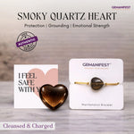 Smoky quartz heart with Gemanifest packaging on a wooden surface