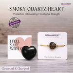 Smoky quartz heart and Gemanifest bracelet on a wooden surface with a neutral background