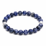 Blue beaded bracelet with silver accents on a white background