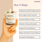 GEMANIFEST crystal infused Thank you candle with a hand holding it, and a list of benefits on a beige background.