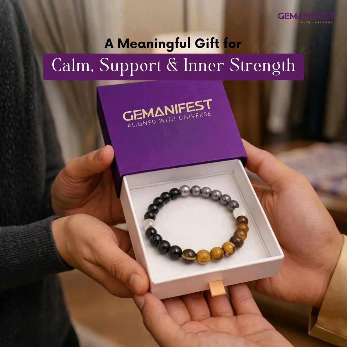 Gemanifest bracelet in a box held by two hands with promotional text.